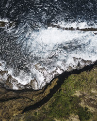 High angle view of water flowing through rocks