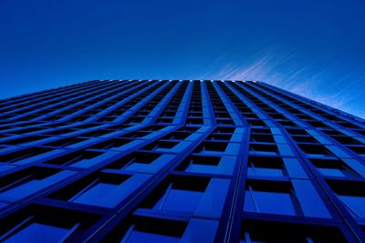 Low angle view of modern building against blue sky