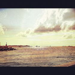 Scenic view of sea against cloudy sky