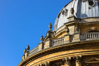 Low angle view of oxford university against blue sky