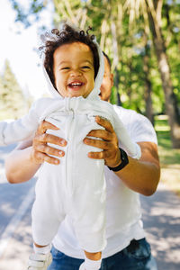 Full length of smiling boy standing outdoors