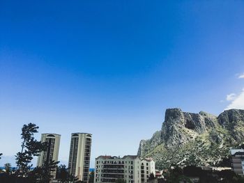 Cityscape against clear blue sky