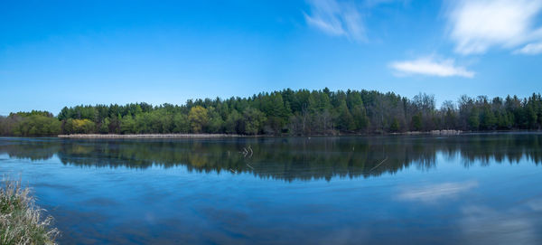 Scenic view of lake against blue sky