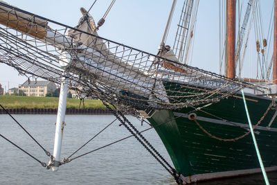 Sailboat on bridge over river against sky