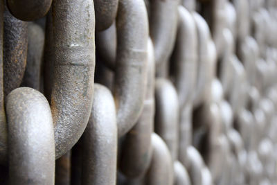 Rusty old brown iron chains, background. wall of hanging vertically massive chains. close-up.