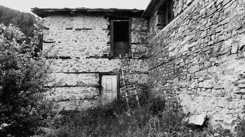 Abandoned building by wall