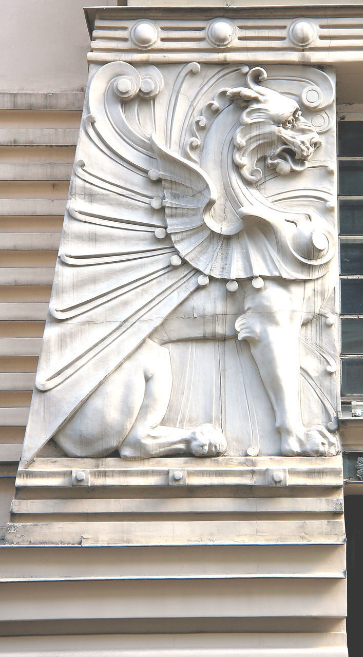 LOW ANGLE VIEW OF ANGEL STATUE AGAINST WHITE WALL