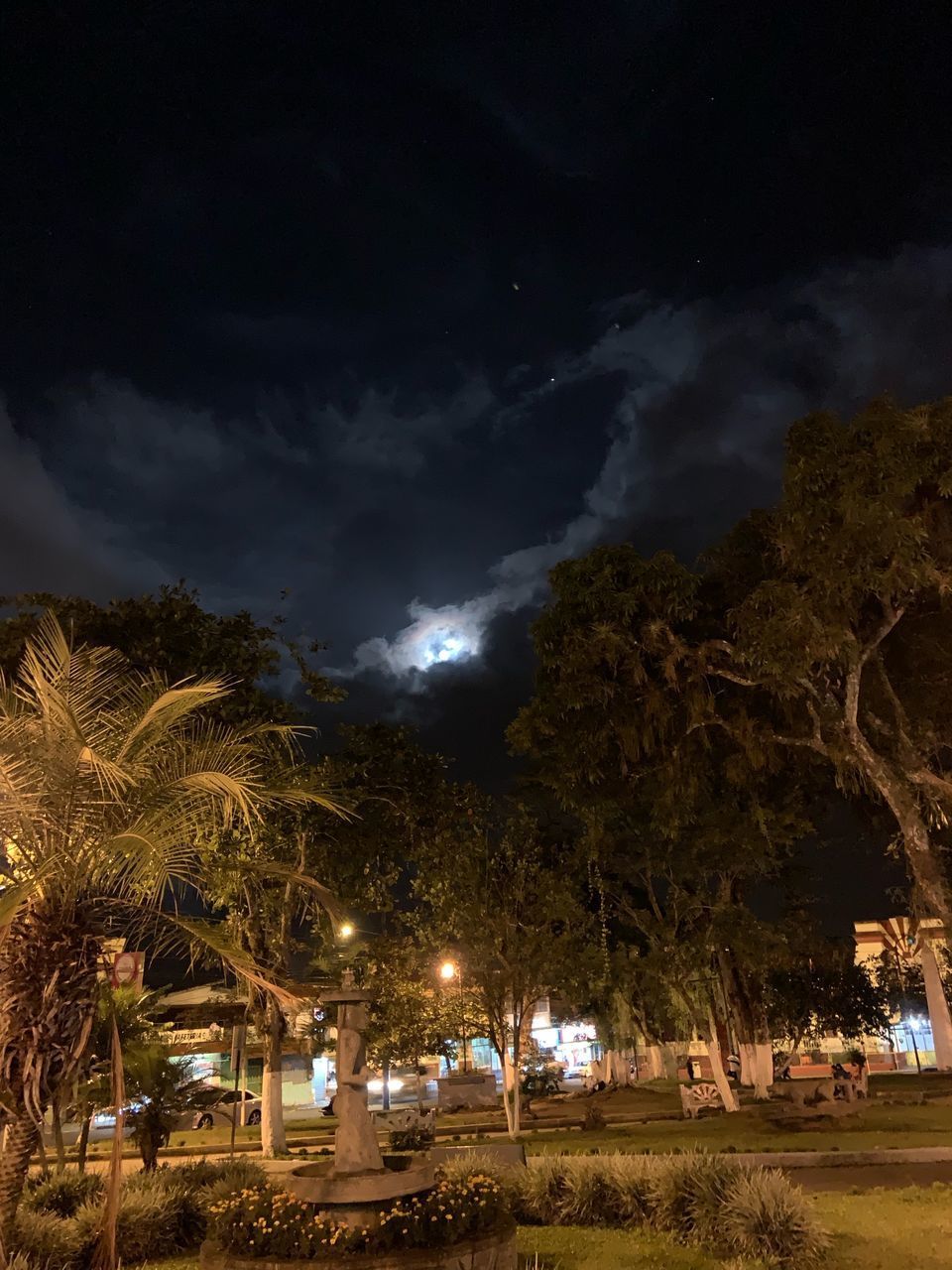 ILLUMINATED STREET AGAINST SKY AT NIGHT