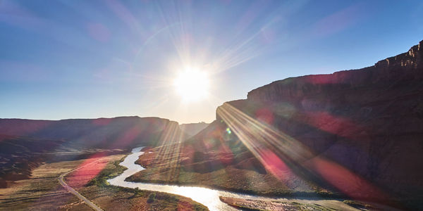 Scenic view of mountains against sky on sunny day