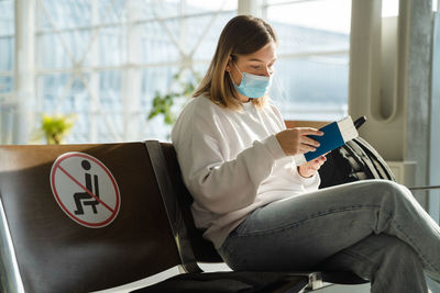 Young woman using laptop while sitting in cafe