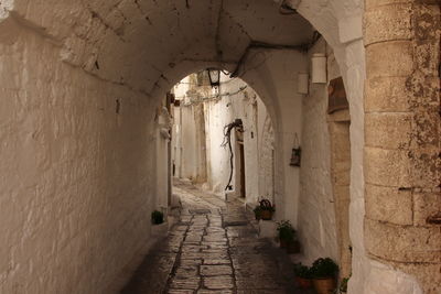 View trough an arch in the medival white village of ostuni, italy