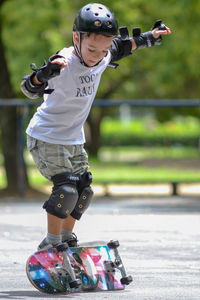 Full length of boy with arms raised