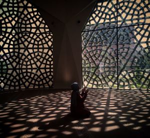 Shadow of man sitting on floor