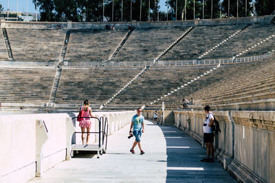 Rear view of people walking on staircase