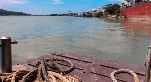 Boats moored at beach against sky