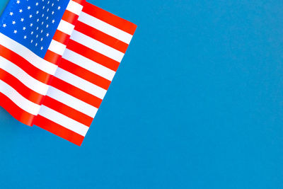 Low angle view of flag against clear blue sky