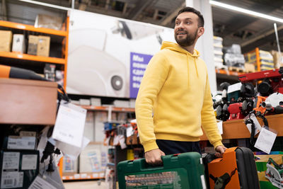 Portrait of young man standing in store