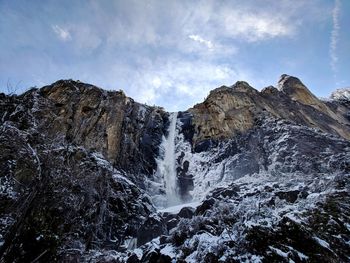 Scenic view of waterfall against sky