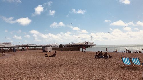 People on beach against sky