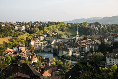 High angle view of townscape by river in city