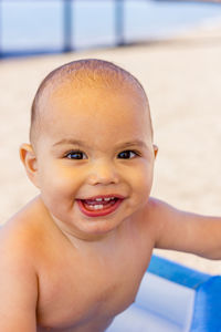 Happy baby boy in an inflatable pool