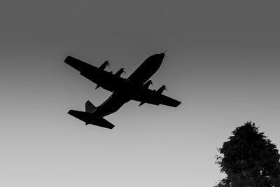 Low angle view of airplane flying against clear sky