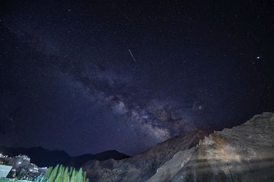 Scenic view of mountains against sky at night