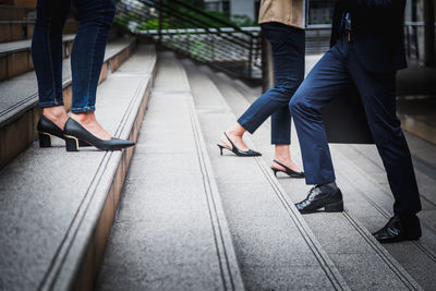 Low section of people walking on footpath