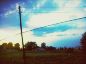 Scenic view of field against cloudy sky