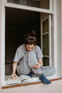 Woman studying at home with headphones