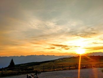 Scenic view of field against sky during sunset