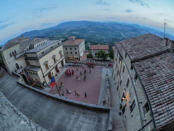 High angle view of people on street amidst buildings in city