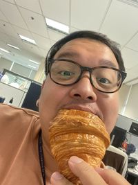 Close-up portrait of a man holding ice cream in restaurant