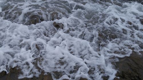 High angle view of waves rushing towards shore