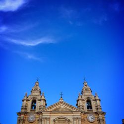 Low angle view of church against blue sky