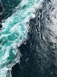 Close-up of sea waves splashing against sky