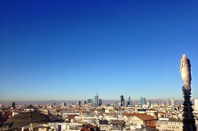 Cityscape against clear blue sky