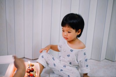 Portrait of cute girl sitting at home