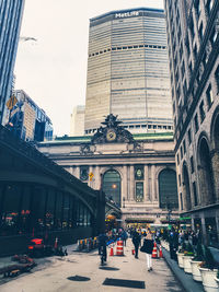 People on street against buildings