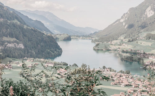 Scenic view of lake and mountains against sky