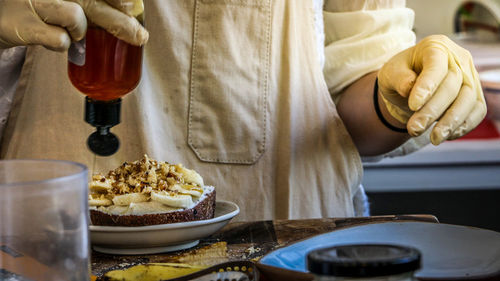 Midsection of man preparing food on table
