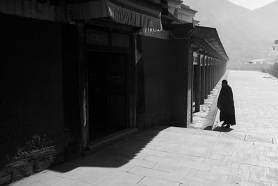 Side view of woman standing on street