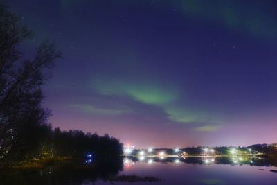 Scenic view of lake against sky at night