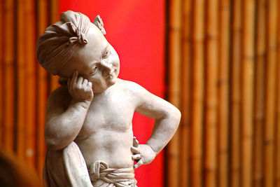 Close-up of shirtless man statue