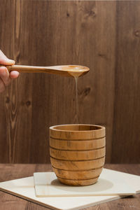 Cropped hand of person preparing food on table