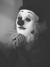 Portrait of sad clown holding mask
