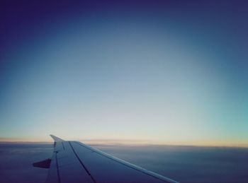 Cropped image of airplane against clear sky