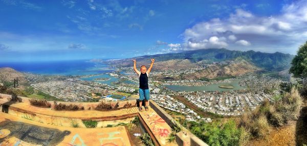 Panoramic view of man standing on mountain against sky