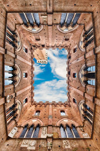 Low angle view of building against cloudy sky