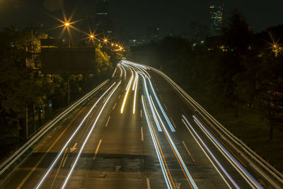 High angle view of light trails on city street at night